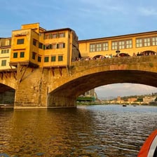 The Arno River flowing through Florence beneath the Ponte Vecchio.