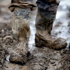 A person taking heavy steps in sturdy boots.