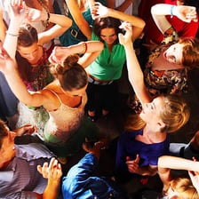 A crowd of people dancing at a lively nighttime party