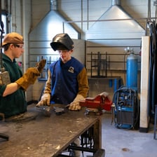 A person employs a tool while completing a task.