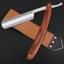 A barber giving a client a traditional straight-razor shave.