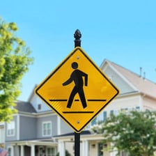 A street sign marking a pedestrian crossing