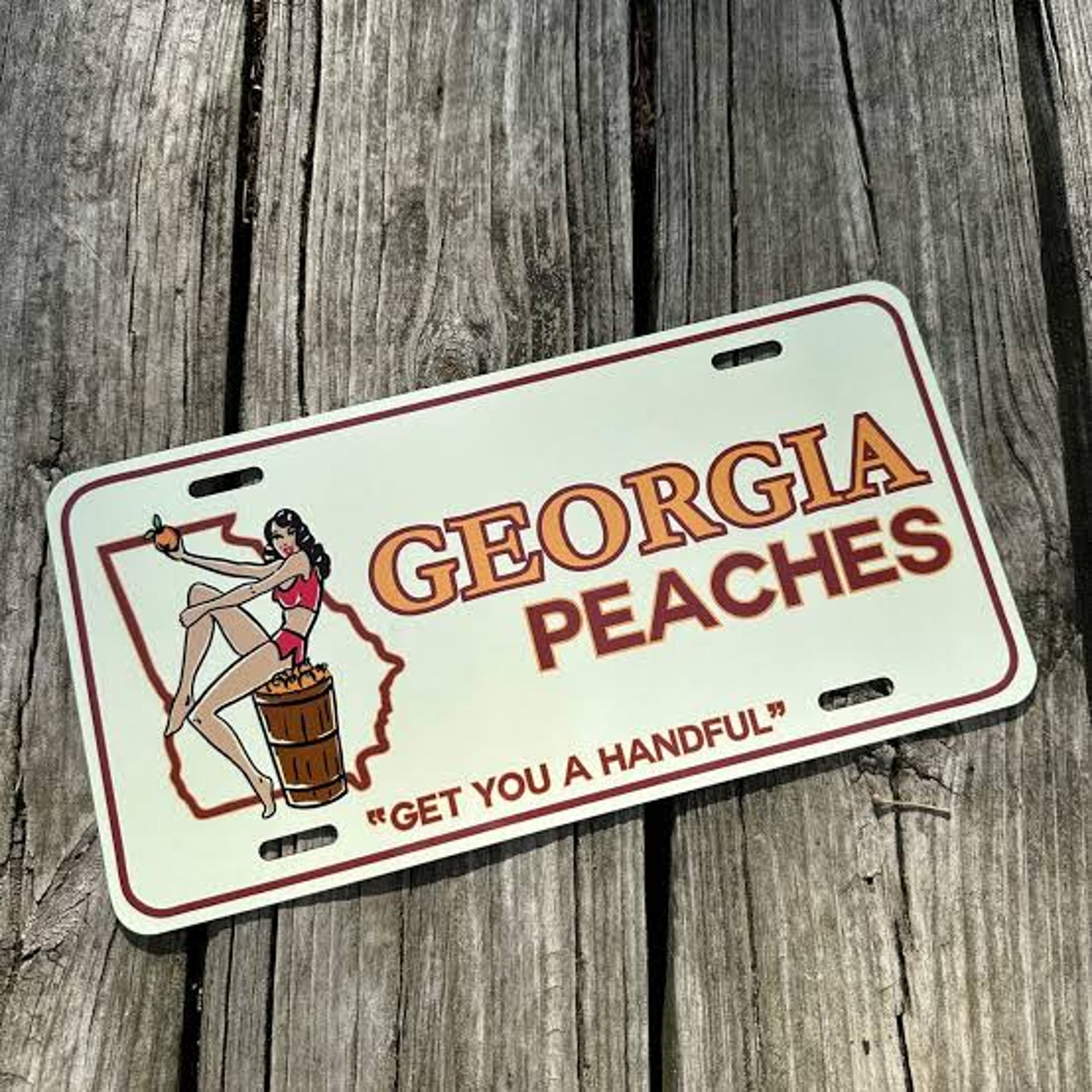 Fruit on a Georgia license plate — NYT Mini Crossword Answer