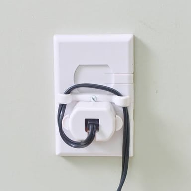 An electrical cord disconnected from a wall outlet.