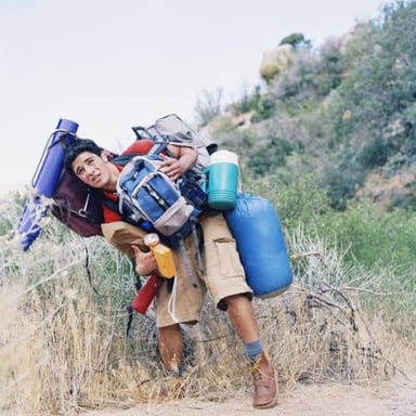 An exhausted hiker strained by a demanding uphill climb