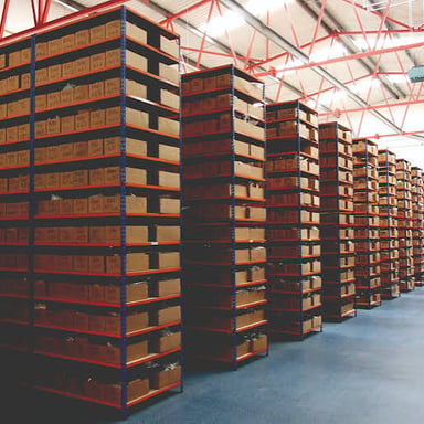 Boxes and goods stored on shelves in a warehouse.