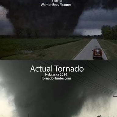 A tornado looms over storm chasers in a scene from *Twister*.