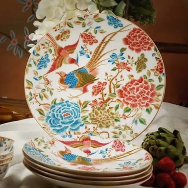 Porcelain dinner plates with a delicate decorative pattern.