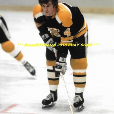 Bobby Orr in a Boston Bruins uniform on the ice.