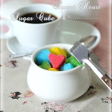 Sugar cubes beside a sweet dessert