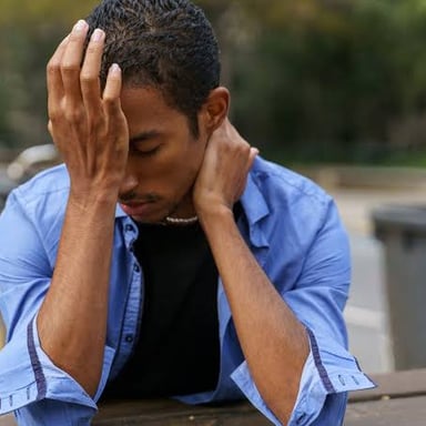 A person looking worried while dealing with a problem.