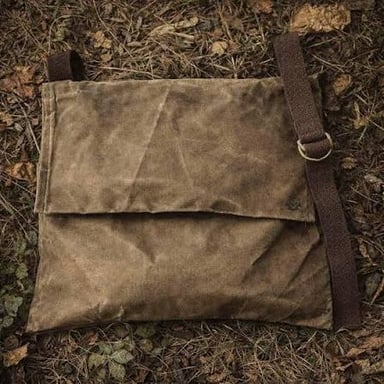 A canvas haversack with one shoulder strap.
