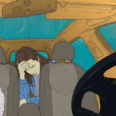 A passenger in a car showing signs of motion sickness.