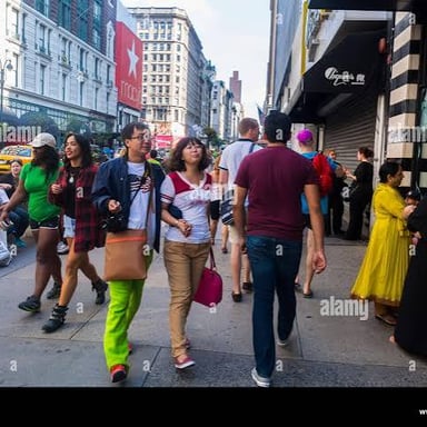 People walking along a city street in Asia.