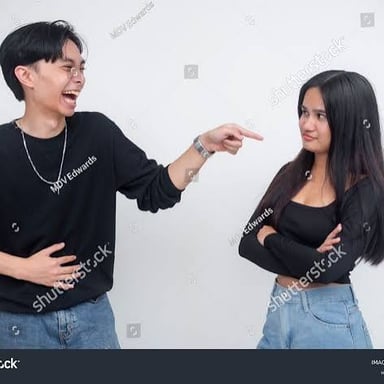 A person gently nudging another person with a finger.