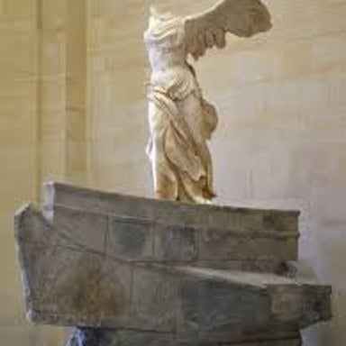 The ancient Winged Victory of Samothrace sculpture displayed in the Louvre.