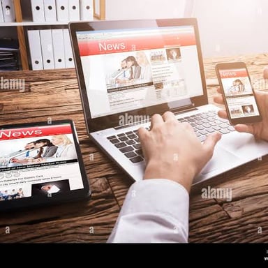 A person reading an article displayed on a laptop screen