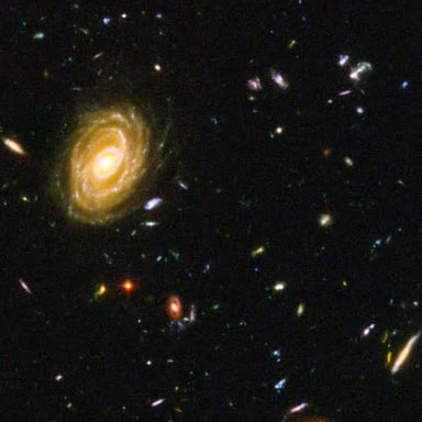Several spiral galaxies visible against a dark background of space.