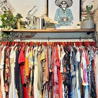 Used clothing and other goods displayed for resale in a consignment shop.