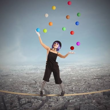 A performer juggling several balls in the air.