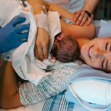 A midwife assisting during a baby's birth.