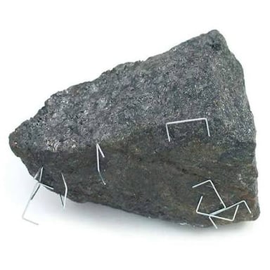 A naturally magnetized lodestone attracting iron filings.
