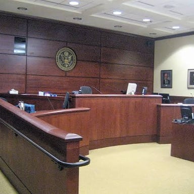 A courtroom with a judge’s bench and seating for a trial