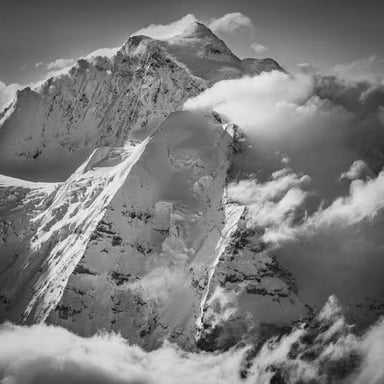 The Jungfrau peak rises among the mountains of the Bernese Alps in Switzerland.