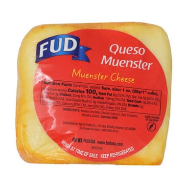 A wedge of pale Muenster cheese with its characteristic orange rind