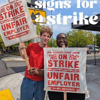 Workers walking together along a picket line.