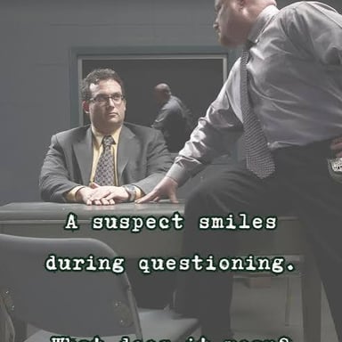 A person sits nervously and fidgets in an interview room.