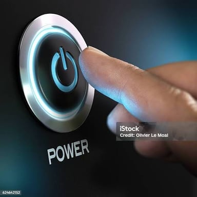A finger pressing a power button to switch on an electronic device.