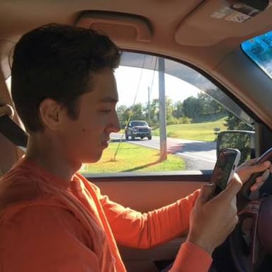 A driver looking at a phone instead of watching the road.
