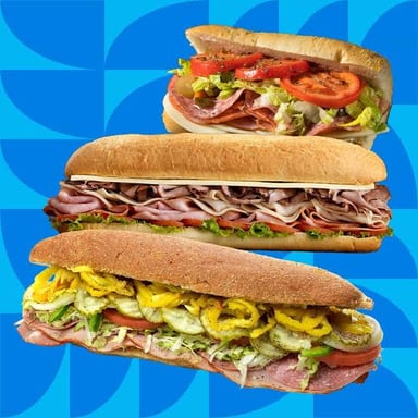A club sandwich shown beside a submarine sub sandwich