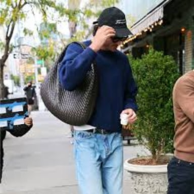 A shopper carrying several shopping bags.