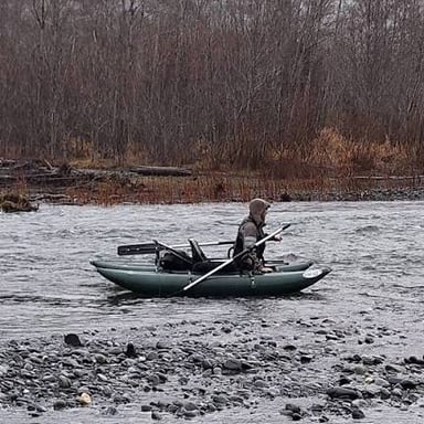 A small boat floating freely on a river current