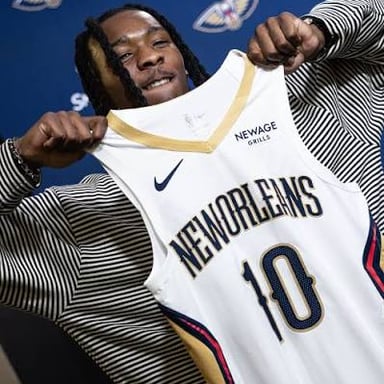 A basketball player wearing a New Orleans Pelicans uniform.