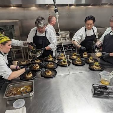 A chef preparing food in a professional kitchen.