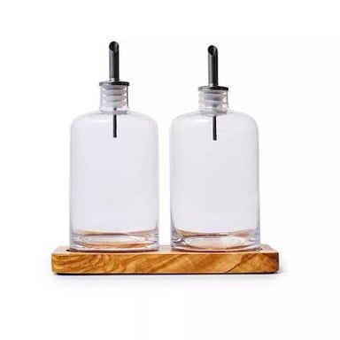Small glass cruets for serving oil and vinegar.