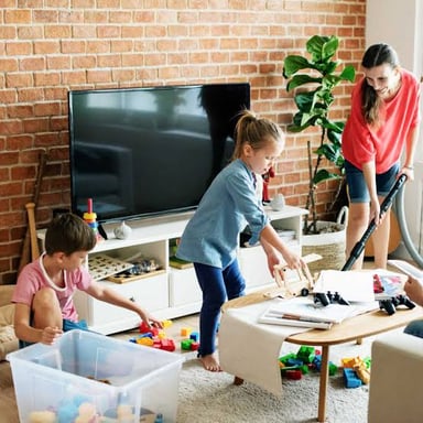 A person arranging items to make a room neater