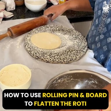 A rolling pin pressing dough into a thin, flat shape.