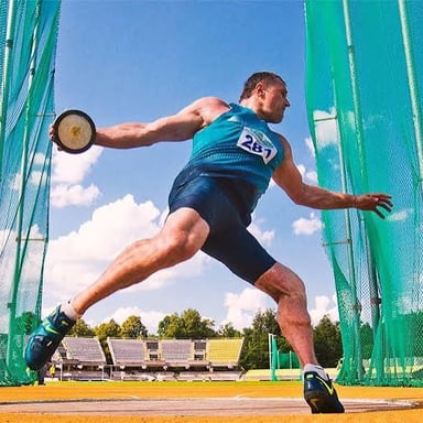 An athlete preparing to throw a discus in a track-and-field competition.
