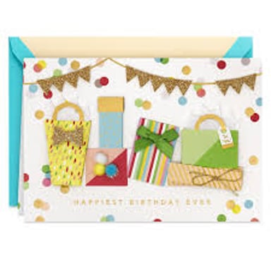 A greeting card placed beside a wrapped present.