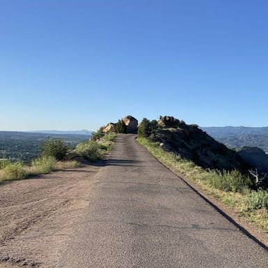 A road extending toward a different destination in the landscape