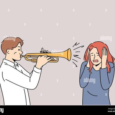 A person covers their ears amid a loud concert.