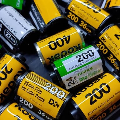 A roll of photographic film beside its small protective canister.