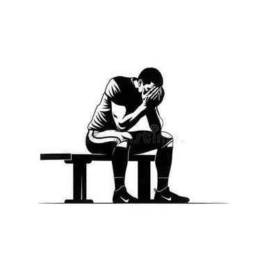 An athlete sits with their head lowered after a loss.