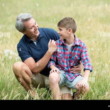 A grandfather and his grandson spend time together outdoors.