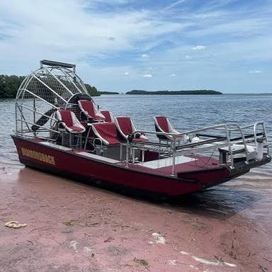 An airboat with a large propeller mounted at the rear.