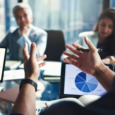A person makes a clear, decisive gesture during a meeting.